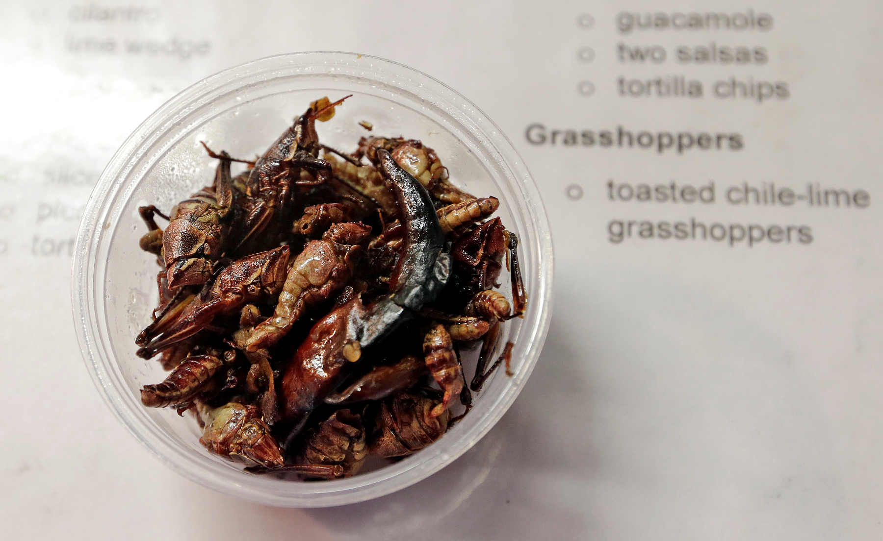Grasshoppers are just one non-conventional item appearing on ball park menus this summer. / The Associated Press