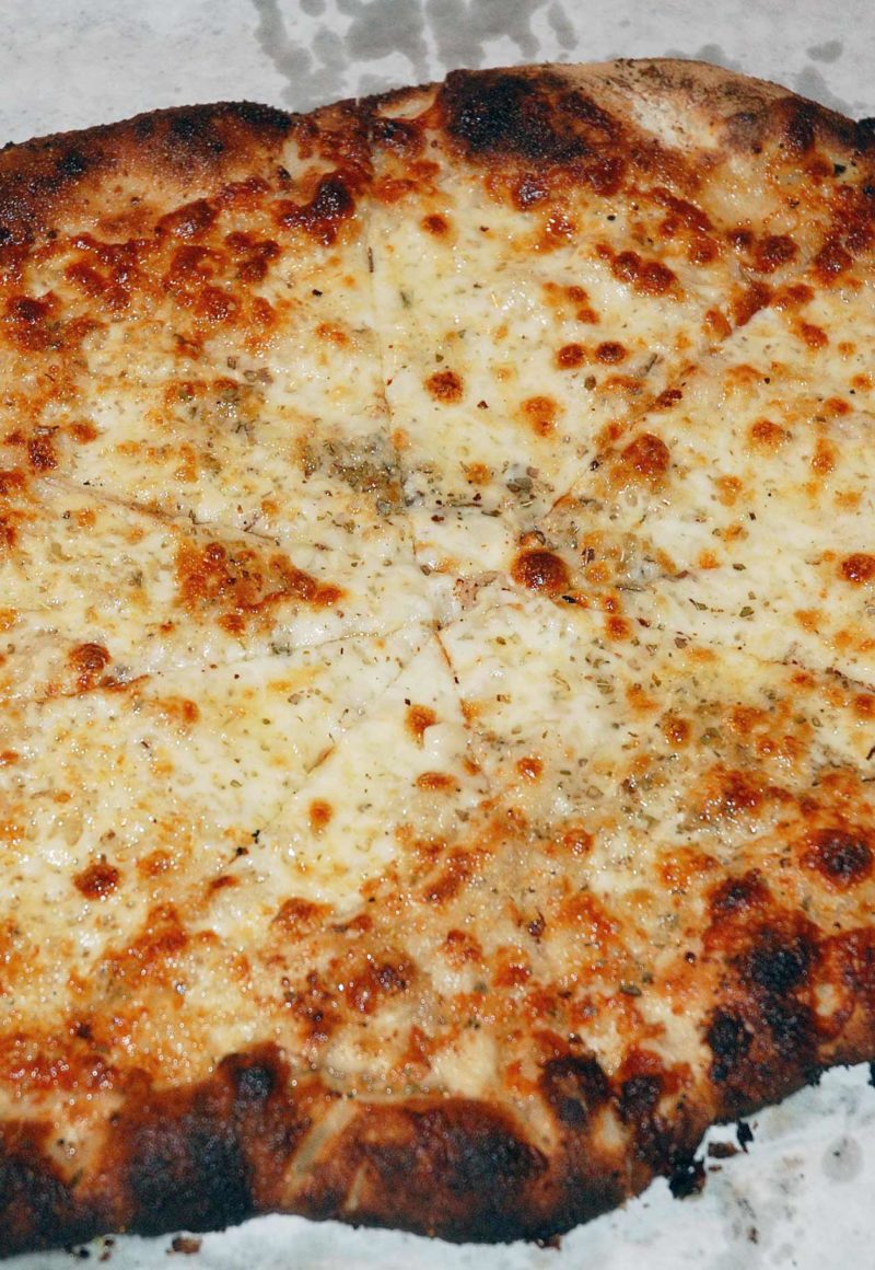 An edited photo of a white pizza a the New Haven restaurant Sally's Pizza. The restaurant was just sold by heirs of the company's founder. - Carl Lender / <a href='https://www.flickr.com/photos/clender/4089912109/'>Flickr</a>