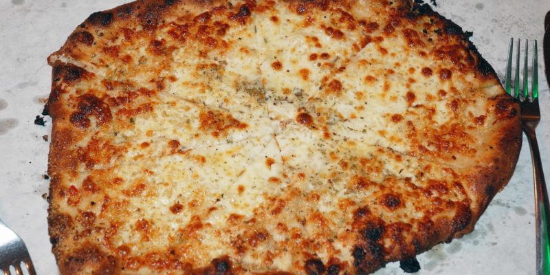 An edited photo of a white pizza a the New Haven restaurant Sally's Pizza. The restaurant was just sold by heirs of the company's founder. - Carl Lender / <a href='https://www.flickr.com/photos/clender/4089912109/'>Flickr</a>