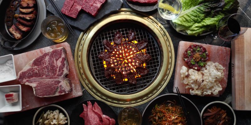 Cote, a Korean barbecue in New York City, has taken the already communal dining experience and heightened it through lighting and other design elements. / Cote NYC