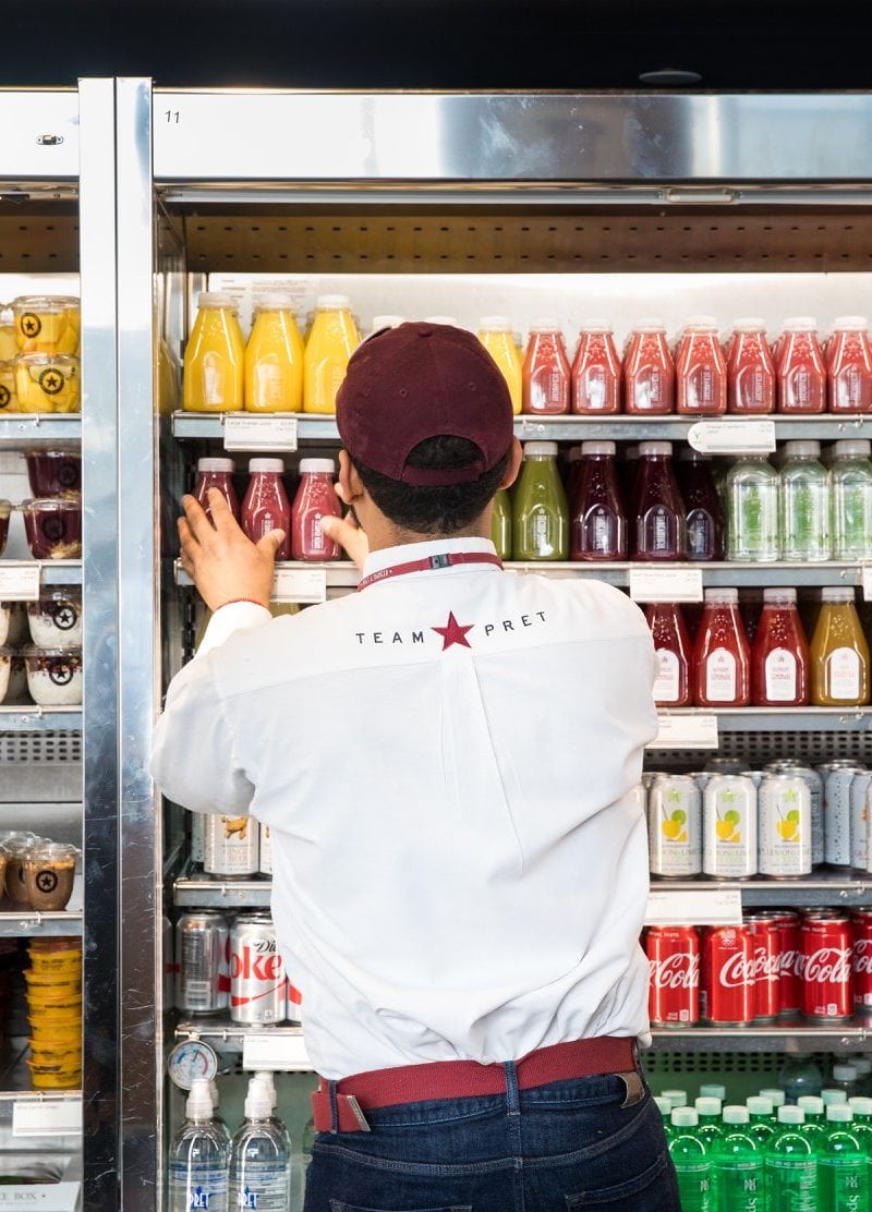 Restaurant workers are at high risk for wage violations. Here, a worker at Pret a Manger stocks drinks. / Pret a Manger