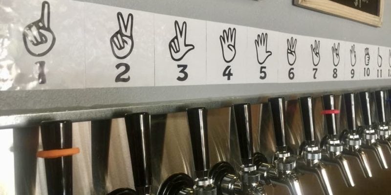 igns above taps at Clackamas River Growlers explain how to order using sign language. / Clackamas River Growlers