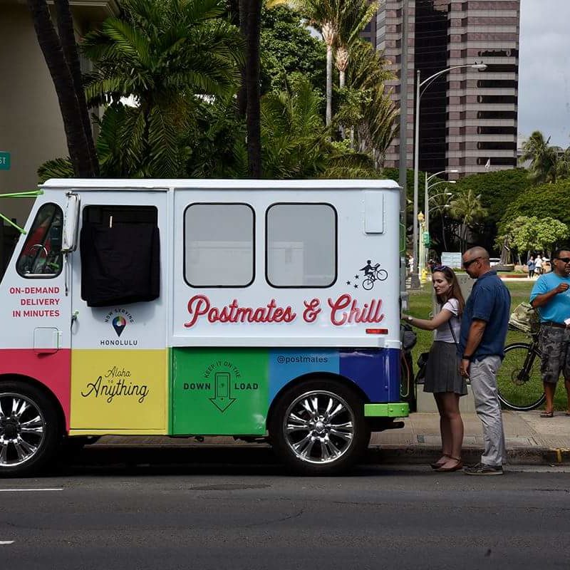 A promotional image of a Postmates pop-up service in Hawaii. - Postmates / <a href='https://m.facebook.com/pg/Postmates/photos/?tab=album&album_id=220750424674635&__xts__%5B0%5D=33.%7B%22logging_data%22%3A%7B%22event_type%22%3A%22tapped_open_page_album%22%2C%22impression_info%22%3A%22eyJmIjp7InBhZ2VfaWQiOiIyMDUyOTE4NDk1NTM4MjYiLCJpdGVtX2NvdW50IjoiMCJ9fQ%22%2C%22surface%22%3A%22mobile_page_photos_tab%22%2C%22interacted_story_type%22%3A%22148947852156832%22%2C%22session_id%22%3A%2240b68becbaa65dda7c1ff9e48e9dd21d%22%7D%7D'>Facebook</a>