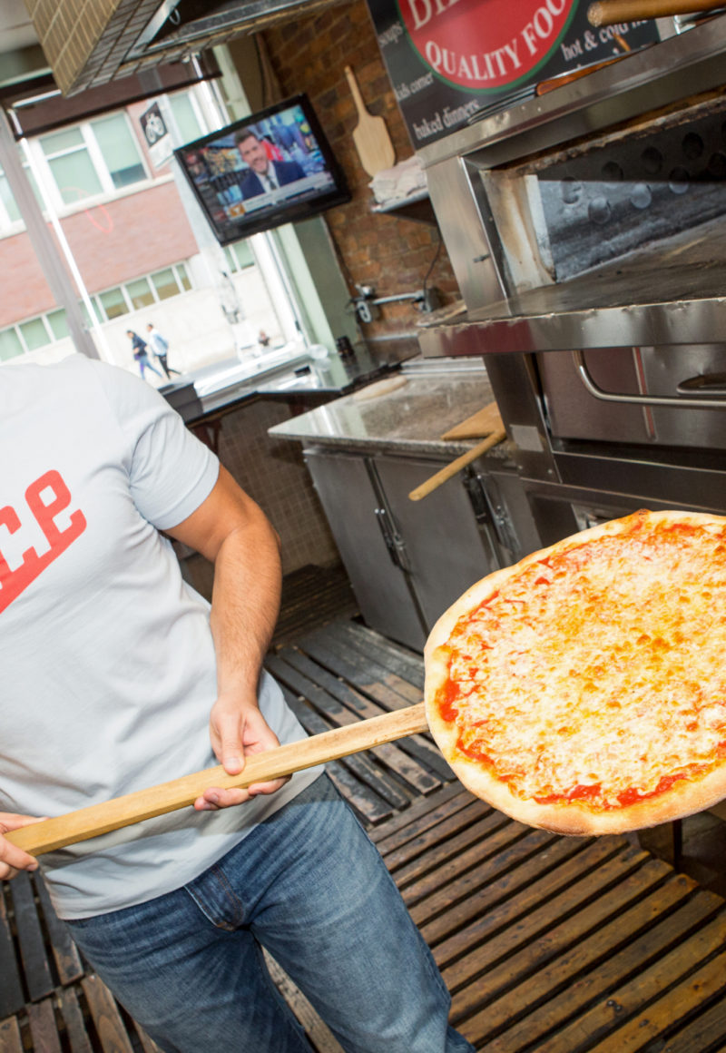 Ilir Sela, founder and CEO of Slice visits one of his company's pizzeria partners. / Slice