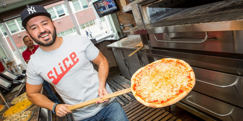 Ilir Sela, founder and CEO of Slice visits one of his company's pizzeria partners. / Slice