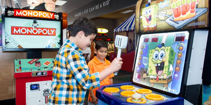 Remodeled stores have more muted tones and wood paneling, rather than the loud colors the chain was known for. / <a href='https://www.chuckecheese.com/coupons-deals'>Chuck E. Cheese</a>